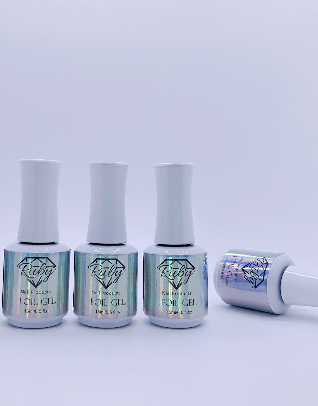Four small bottles of Ruby Foil Transfer Gel with white caps, labeled with the product name, positioned against a light background.