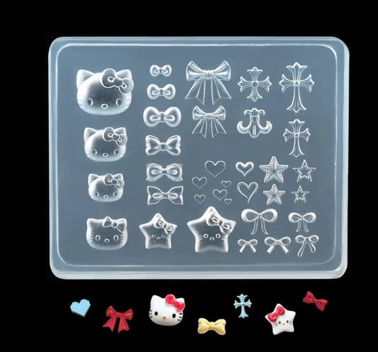 Silicone mold with various shapes including Hello Kitty, bows, and stars on a clear background.
