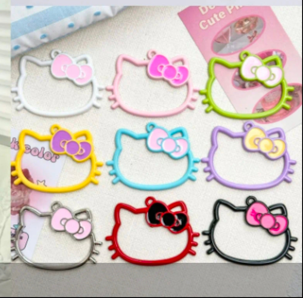 Set of colorful cat-shaped hair accessories with bows on a light background