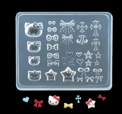 Silicone mold with various shapes including Hello Kitty, bows, and stars on a clear background.
