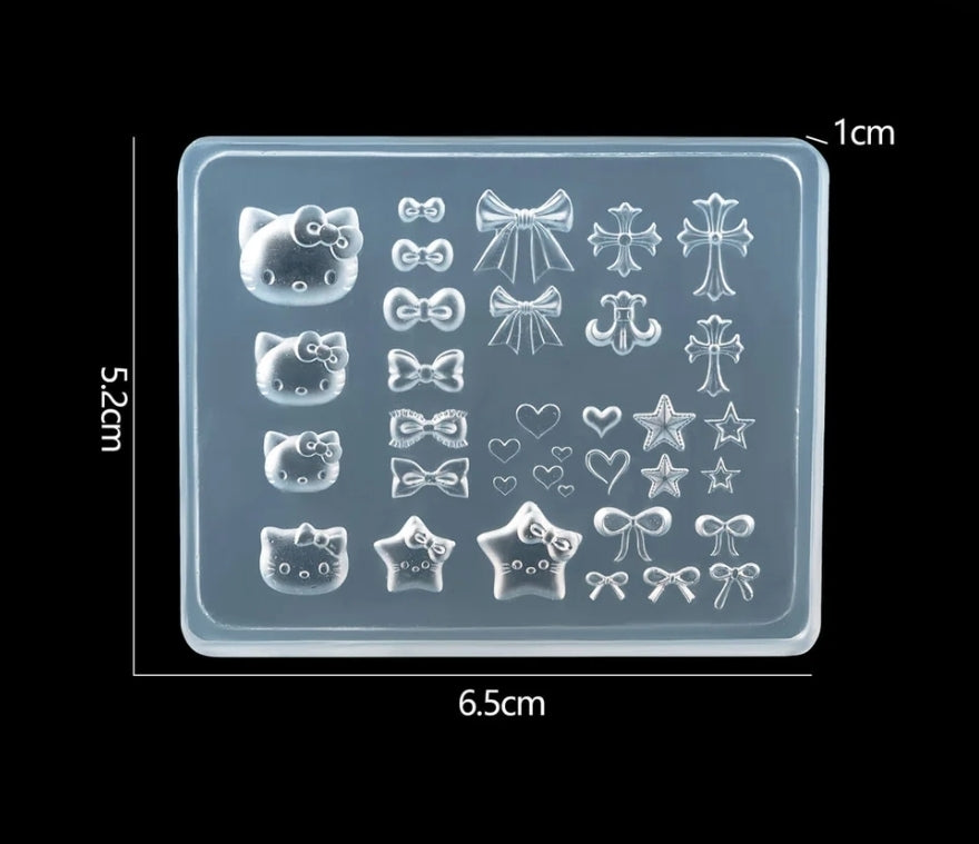 Silicone mold with various shapes including cats, bows, and stars on a black background.